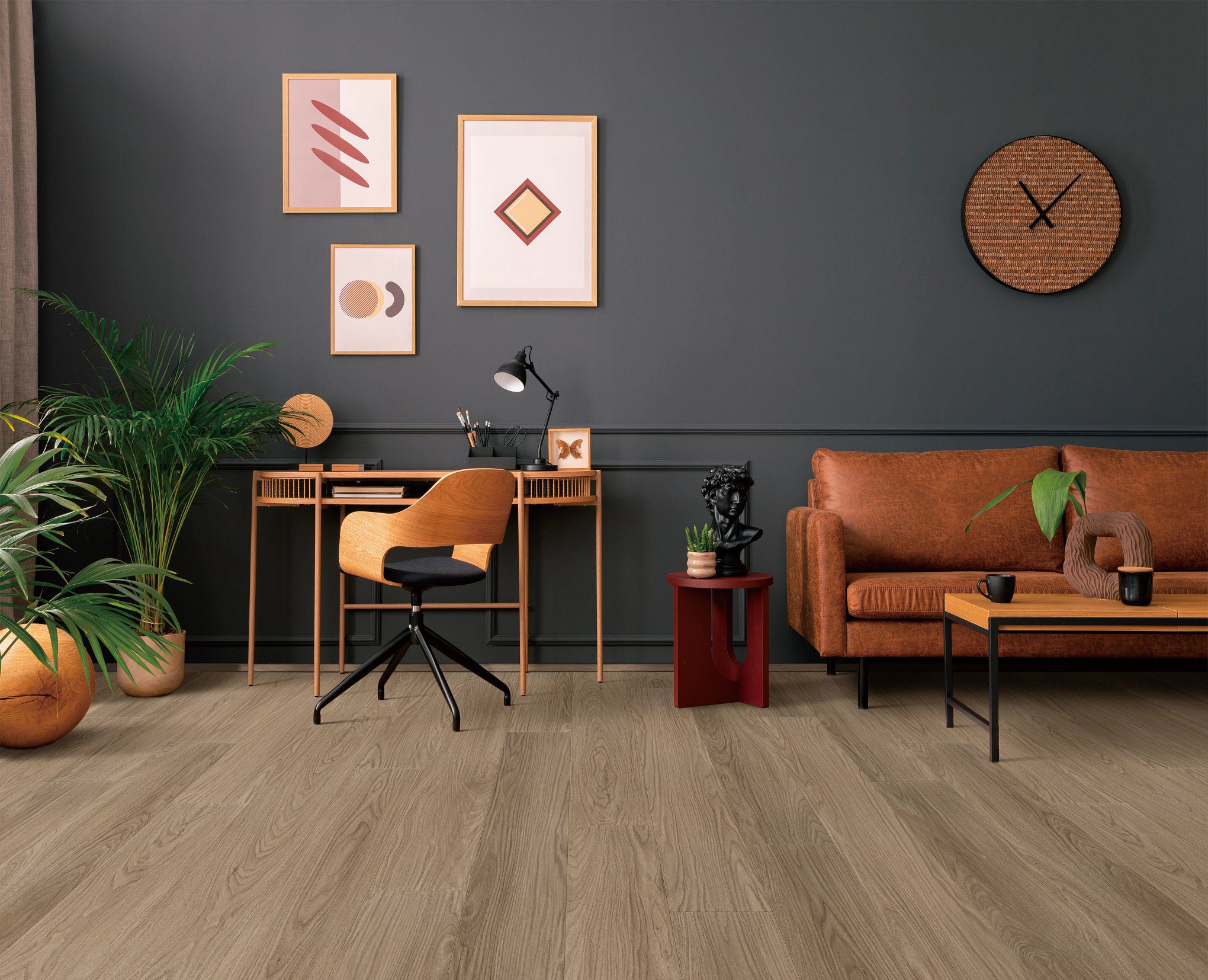 A living room with a couch, chair and desk.