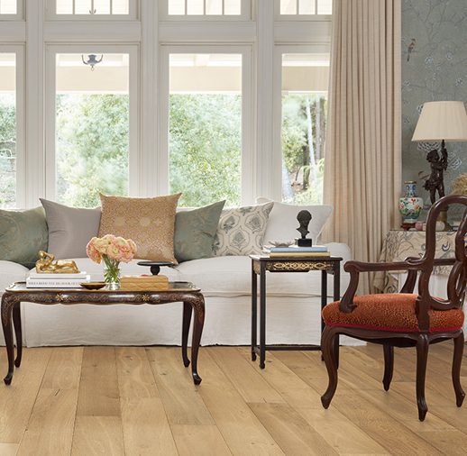 A living room with hard wood floors and furniture.