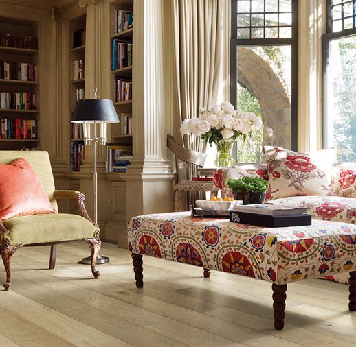 A living room with a large window and wooden floors