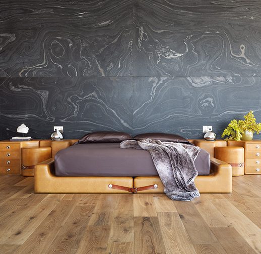 A bed with a wooden frame and two night stands