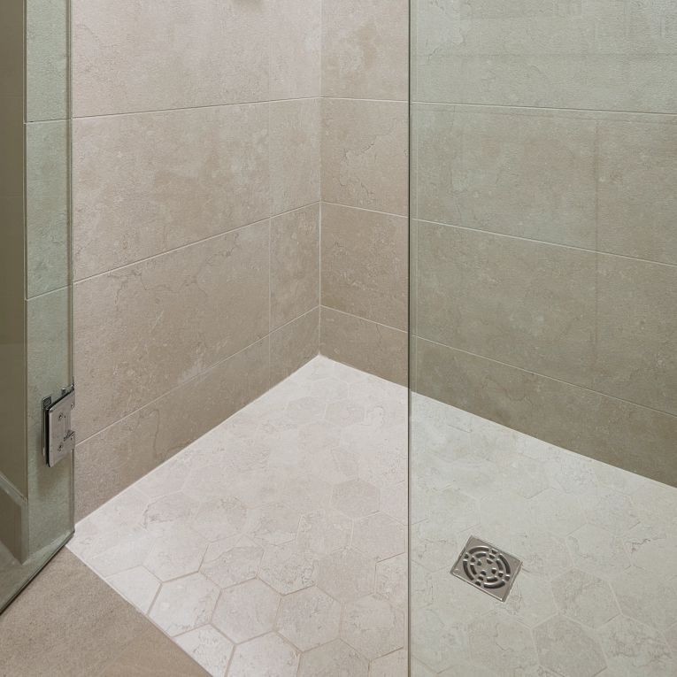 A bathroom with a shower and tiled floor
