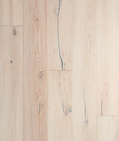 A white wood floor with some cracks on it