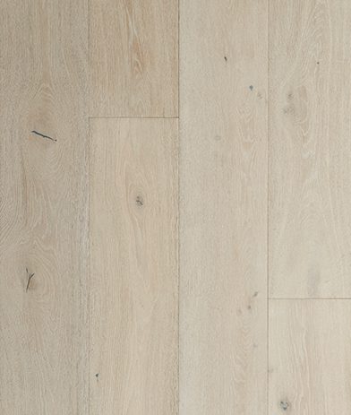 A white wood floor with some brown lines