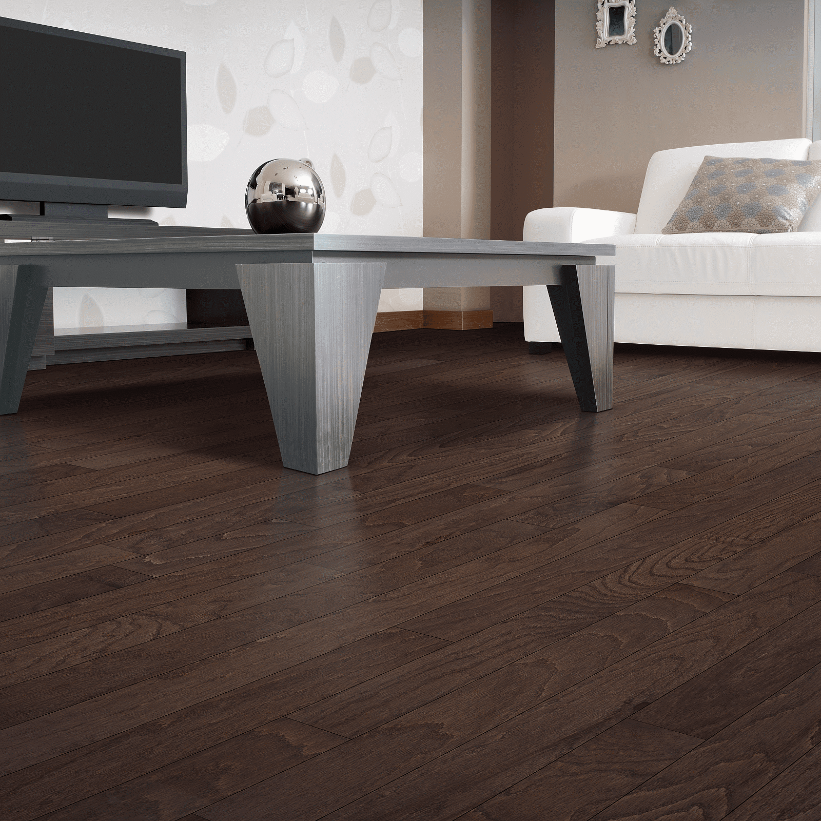 A living room with dark wood floors and white furniture.
