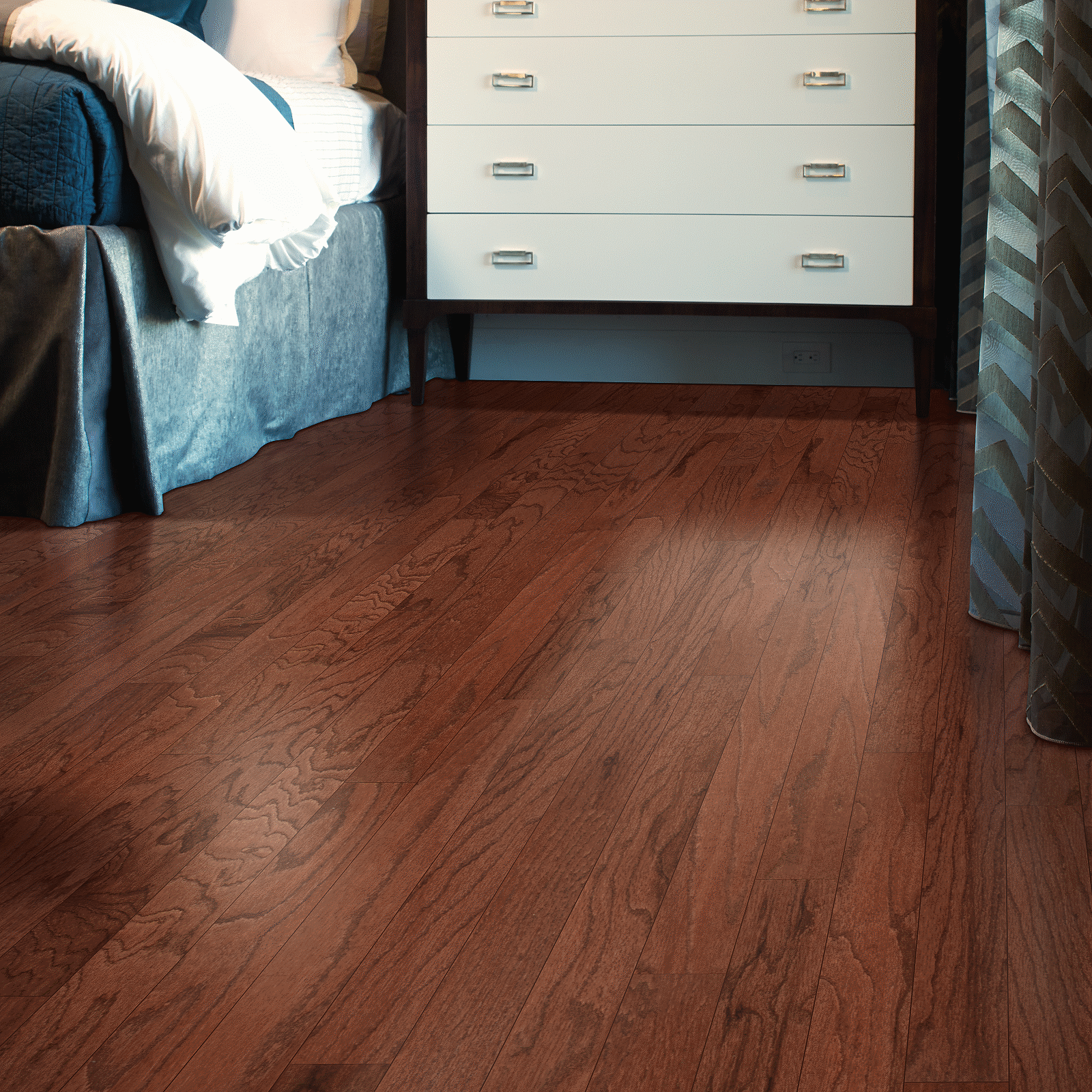 A bedroom with hardwood floors and a bed.