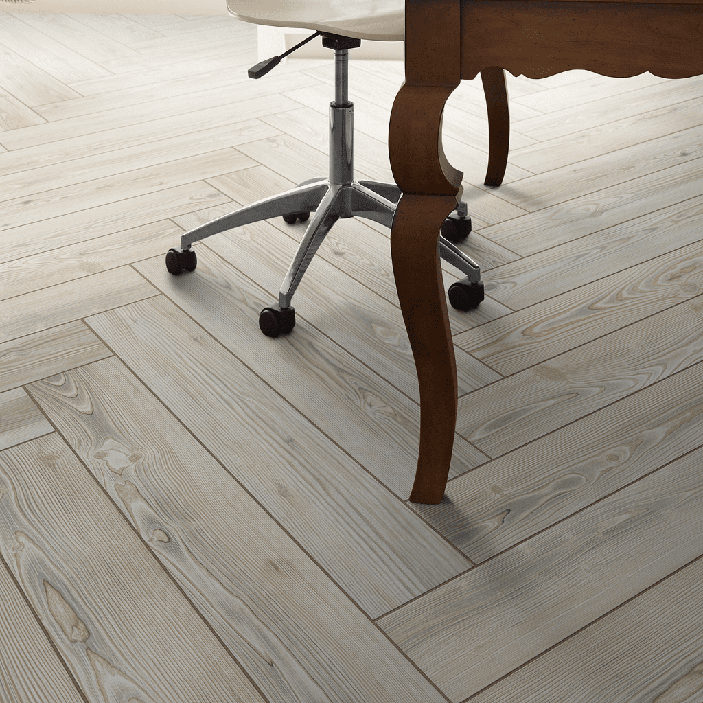 A wooden floor with a chair and table in the background.