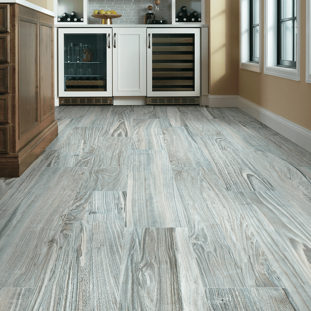 A kitchen with white walls and wooden floors.