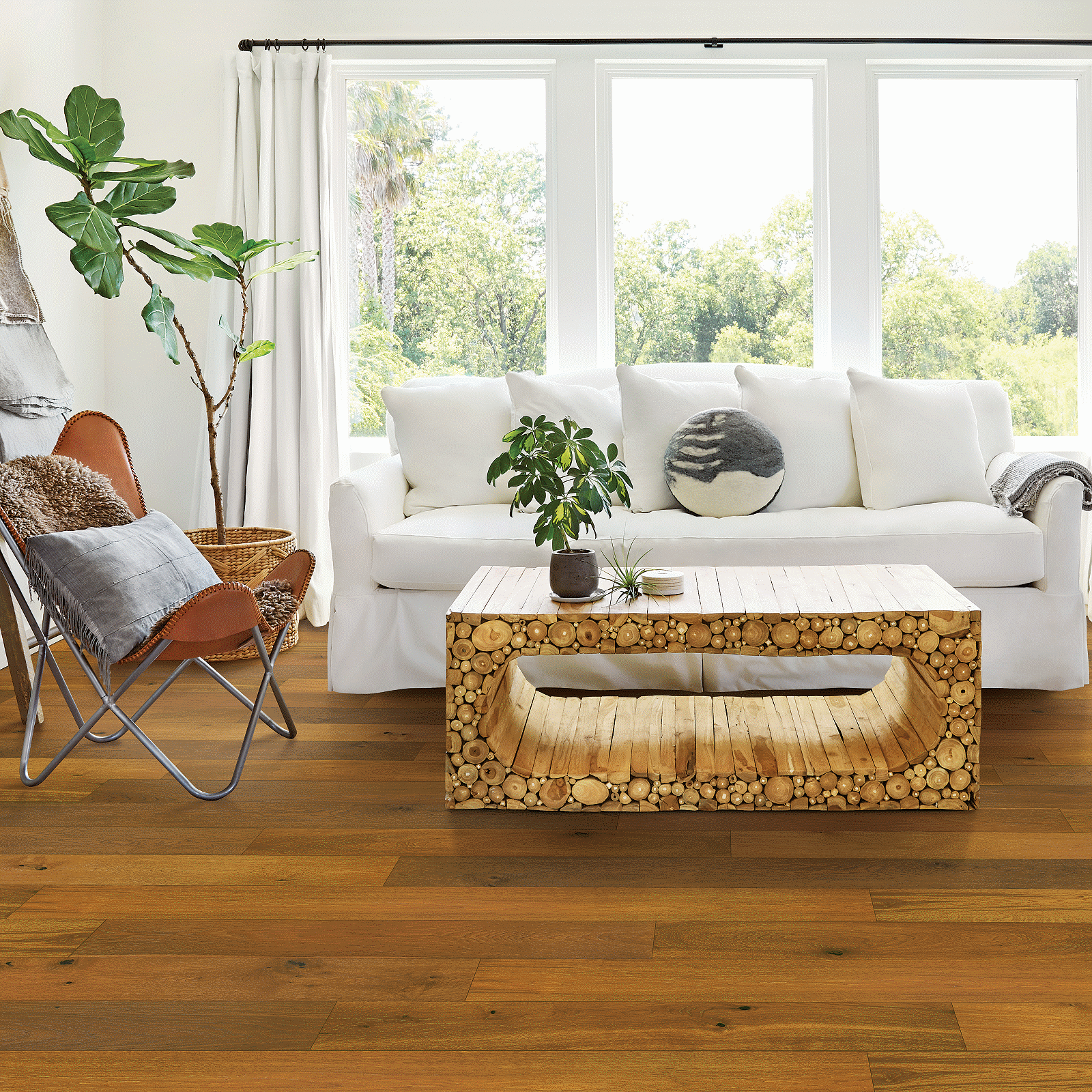 A living room with a couch, chair and table.