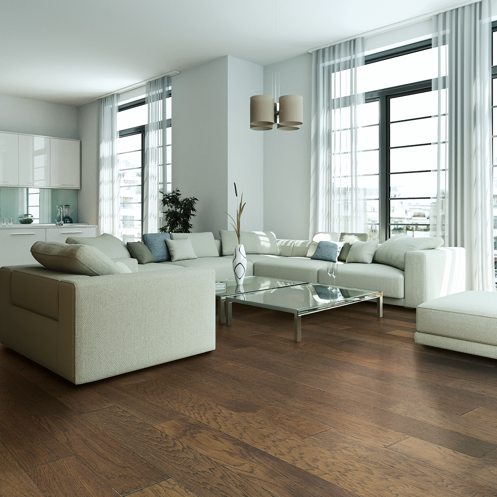 A living room with white furniture and large windows.