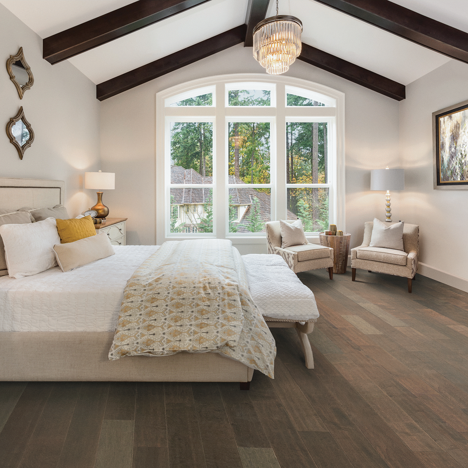 A bedroom with two large windows and a bed.