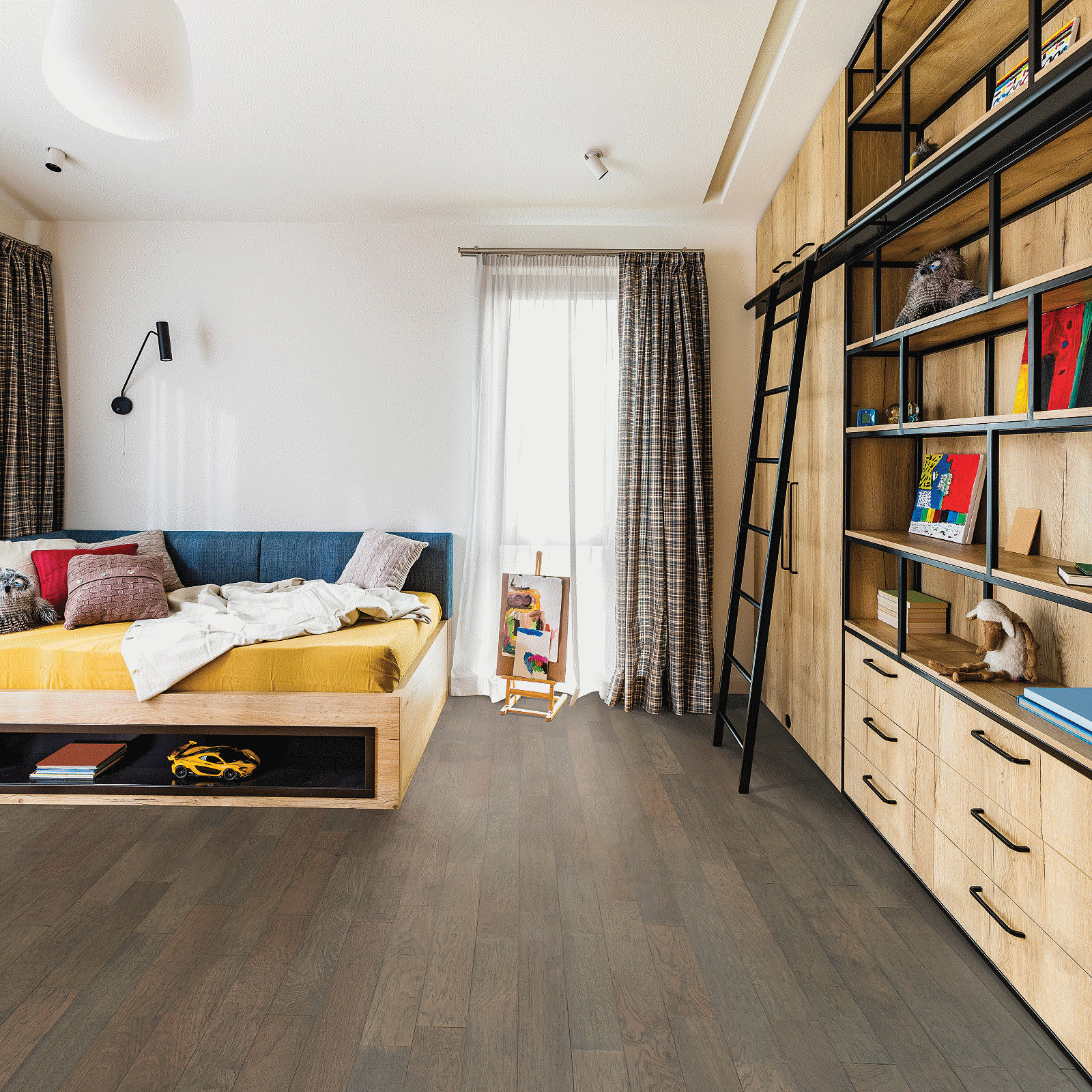 A bedroom with a bed, bookshelf and bookcase.