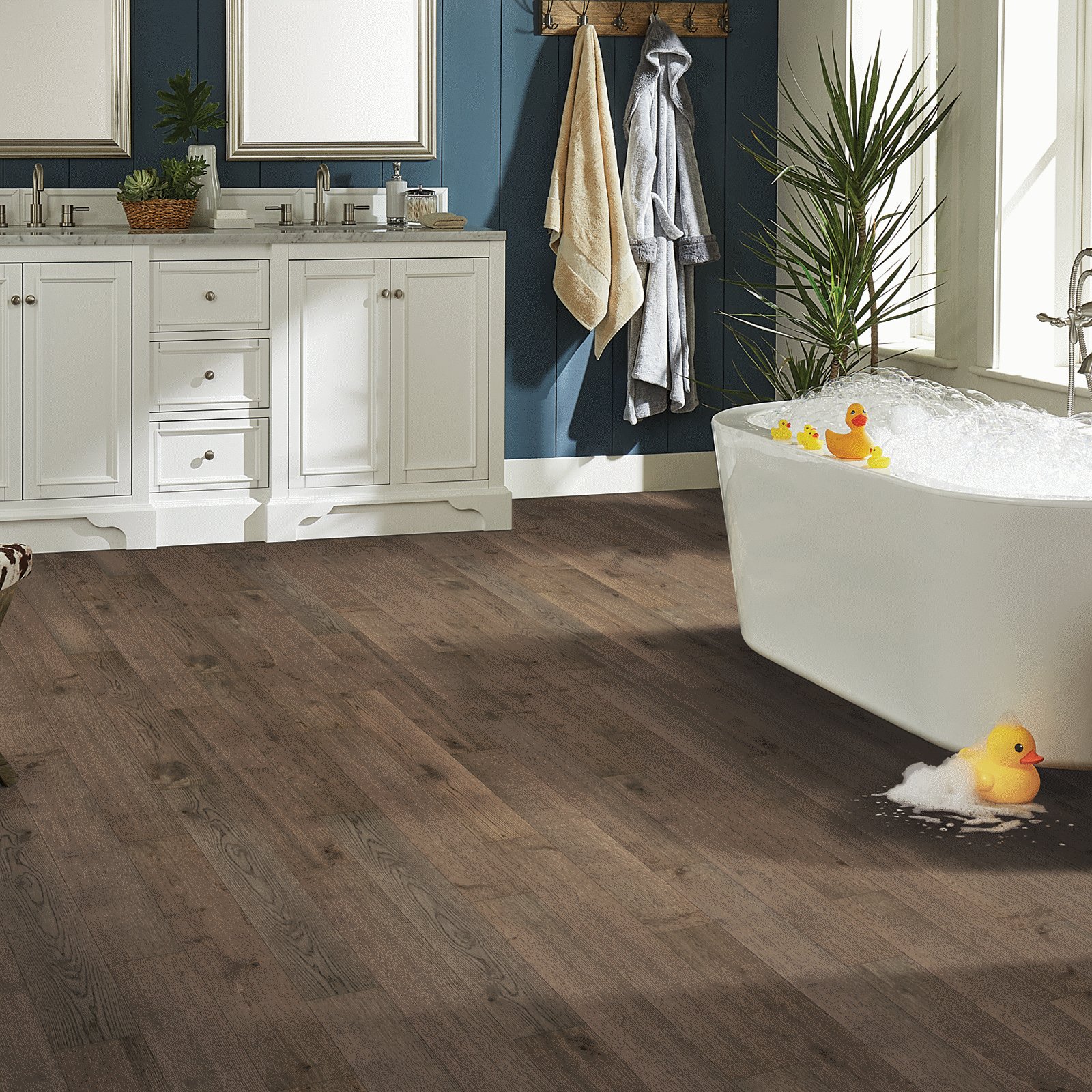A bathroom with a tub and sink, two sinks, and a large mirror.