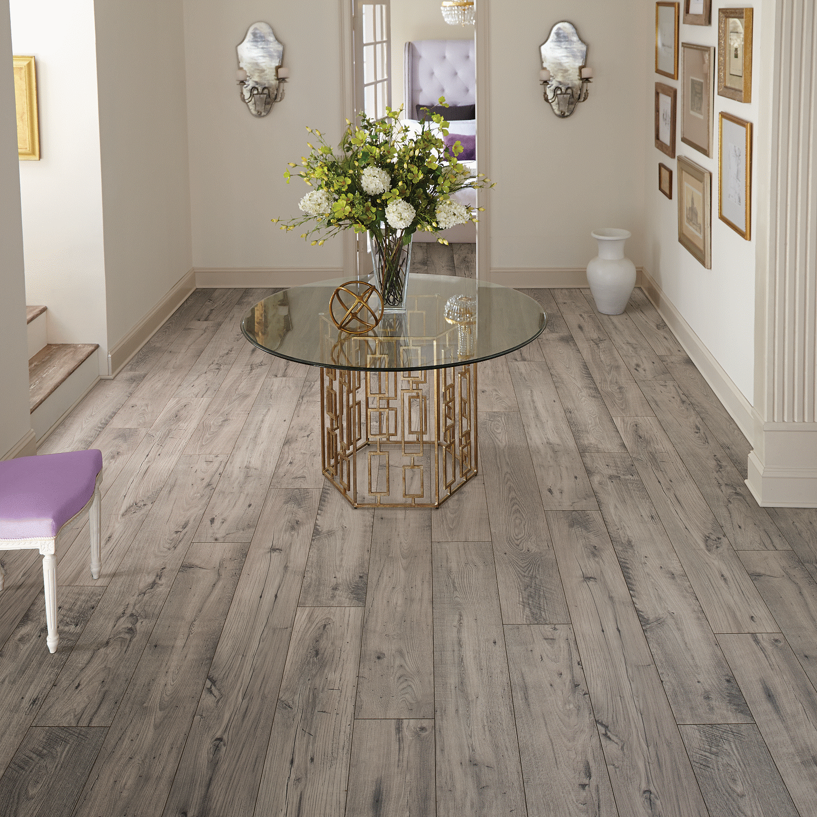 A room with a table and chairs, flowers in the center of it.