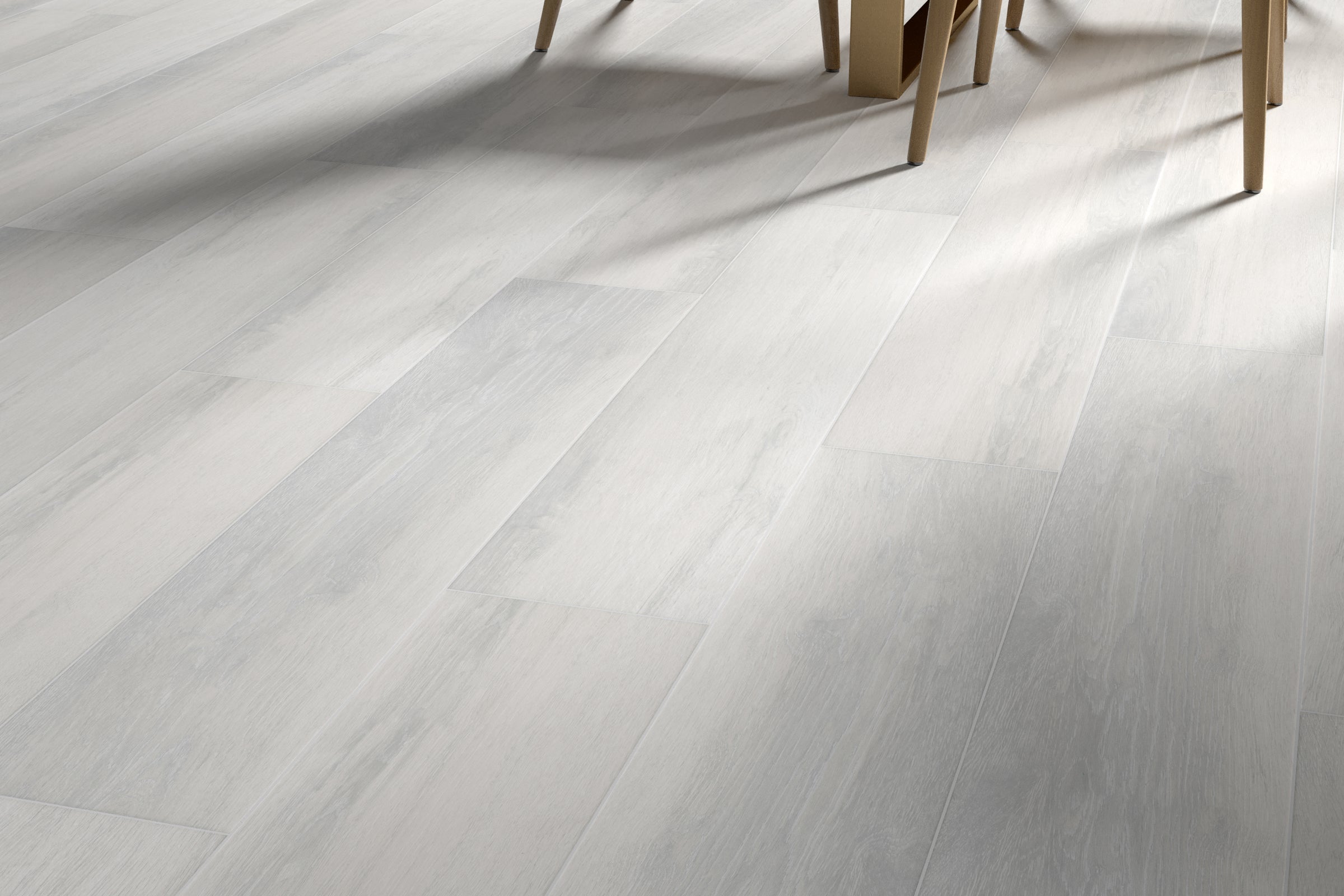 A white floor with some chairs in the background