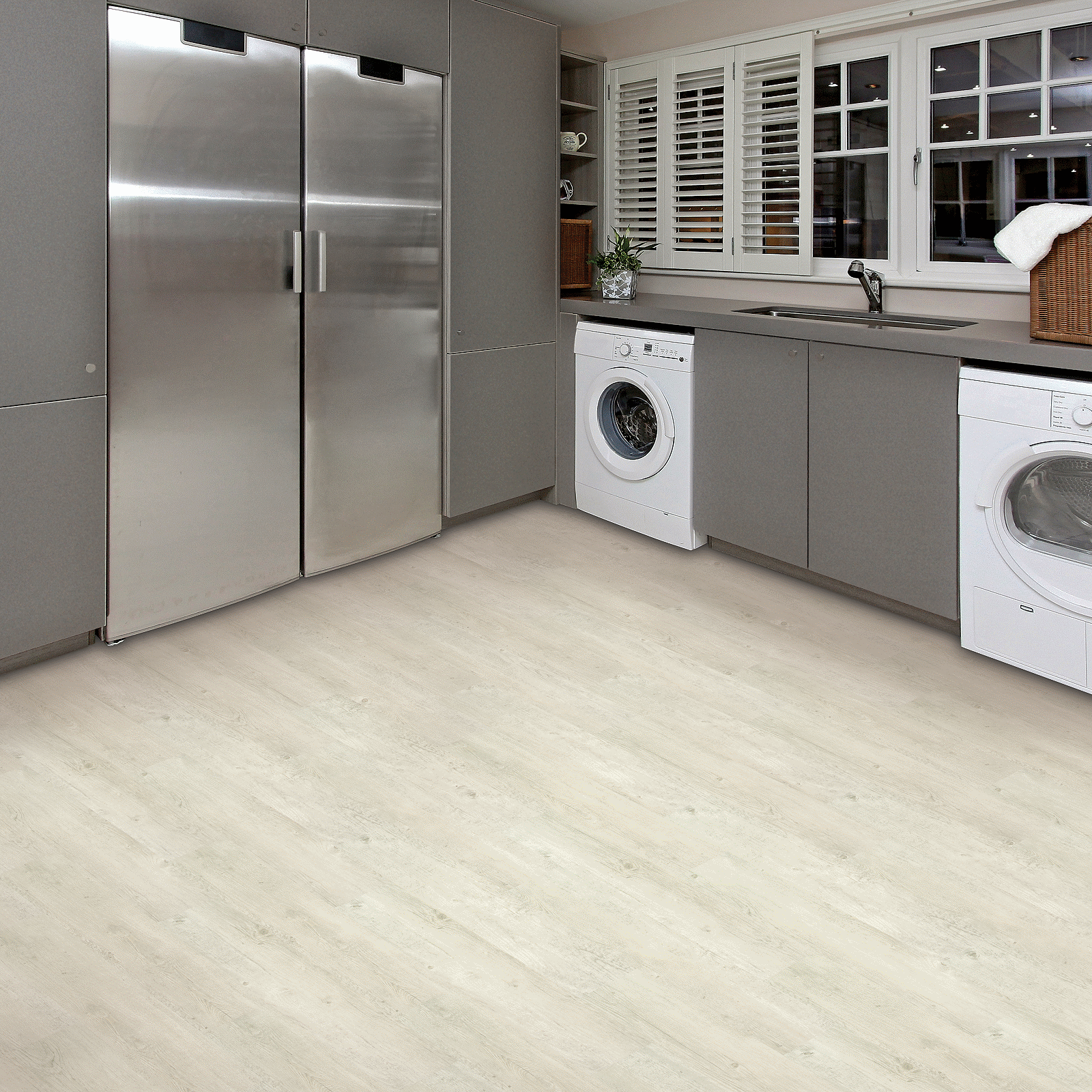 A kitchen with stainless steel appliances and white cabinets.