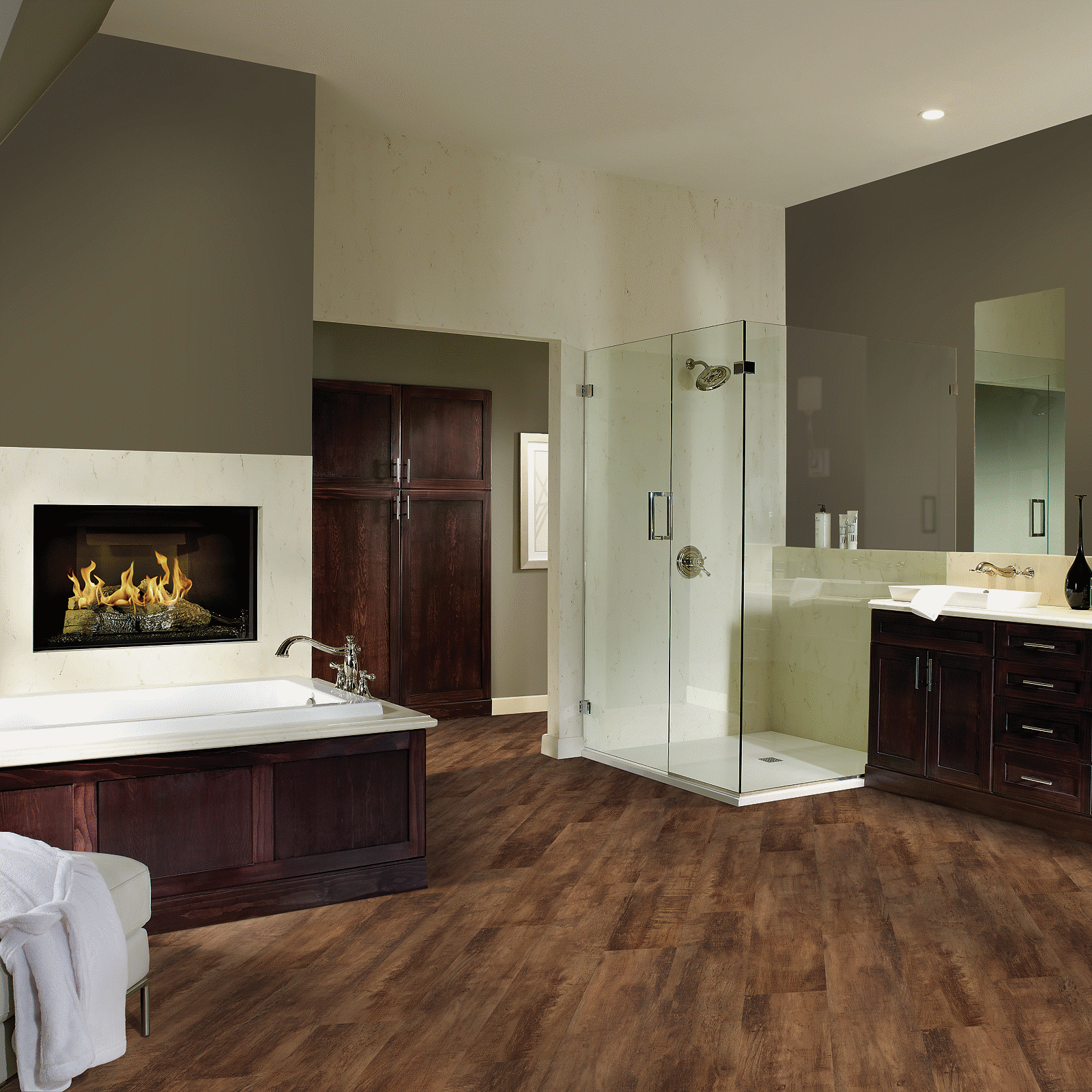 A bathroom with wood floors and a fireplace.
