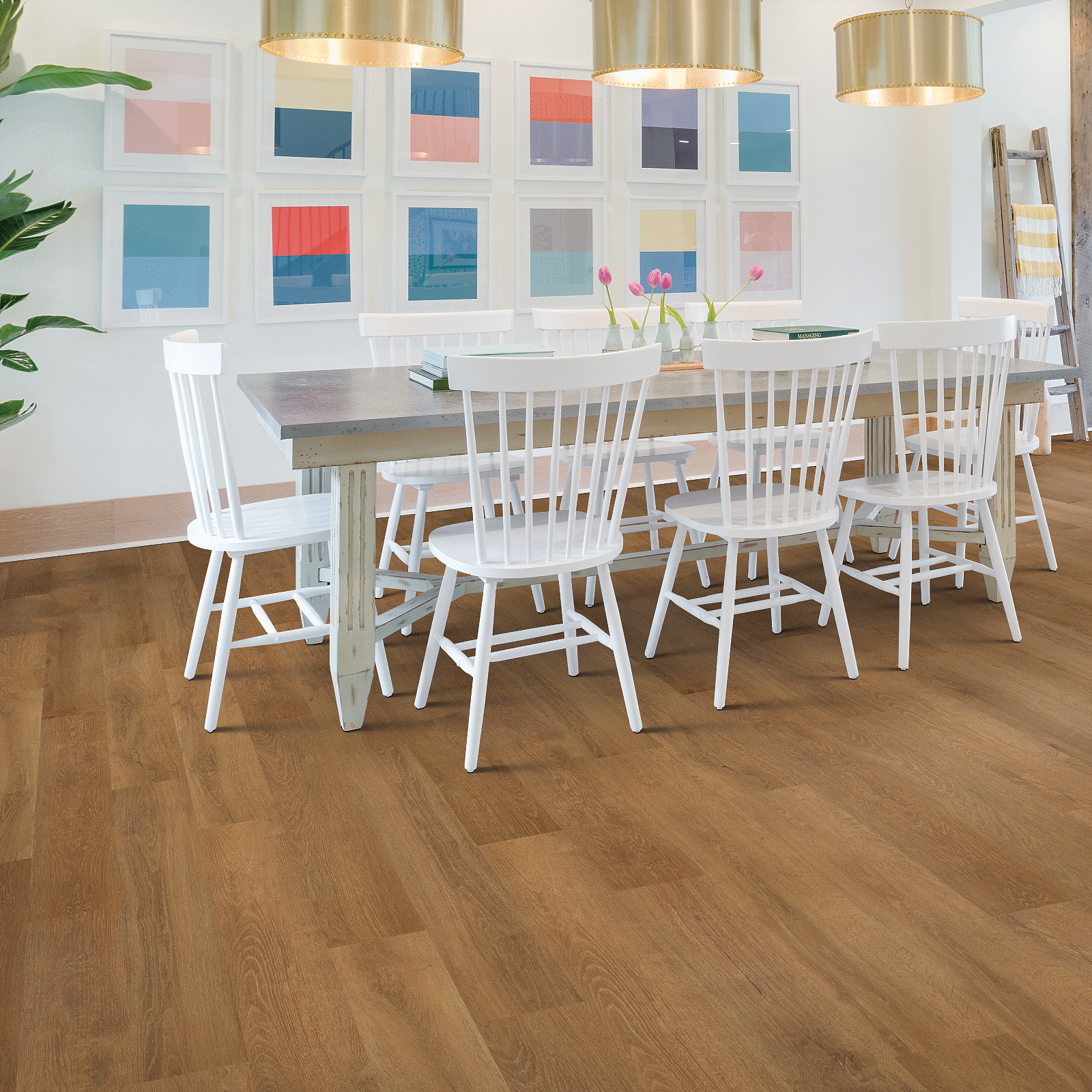 A dining room with white chairs and a table.