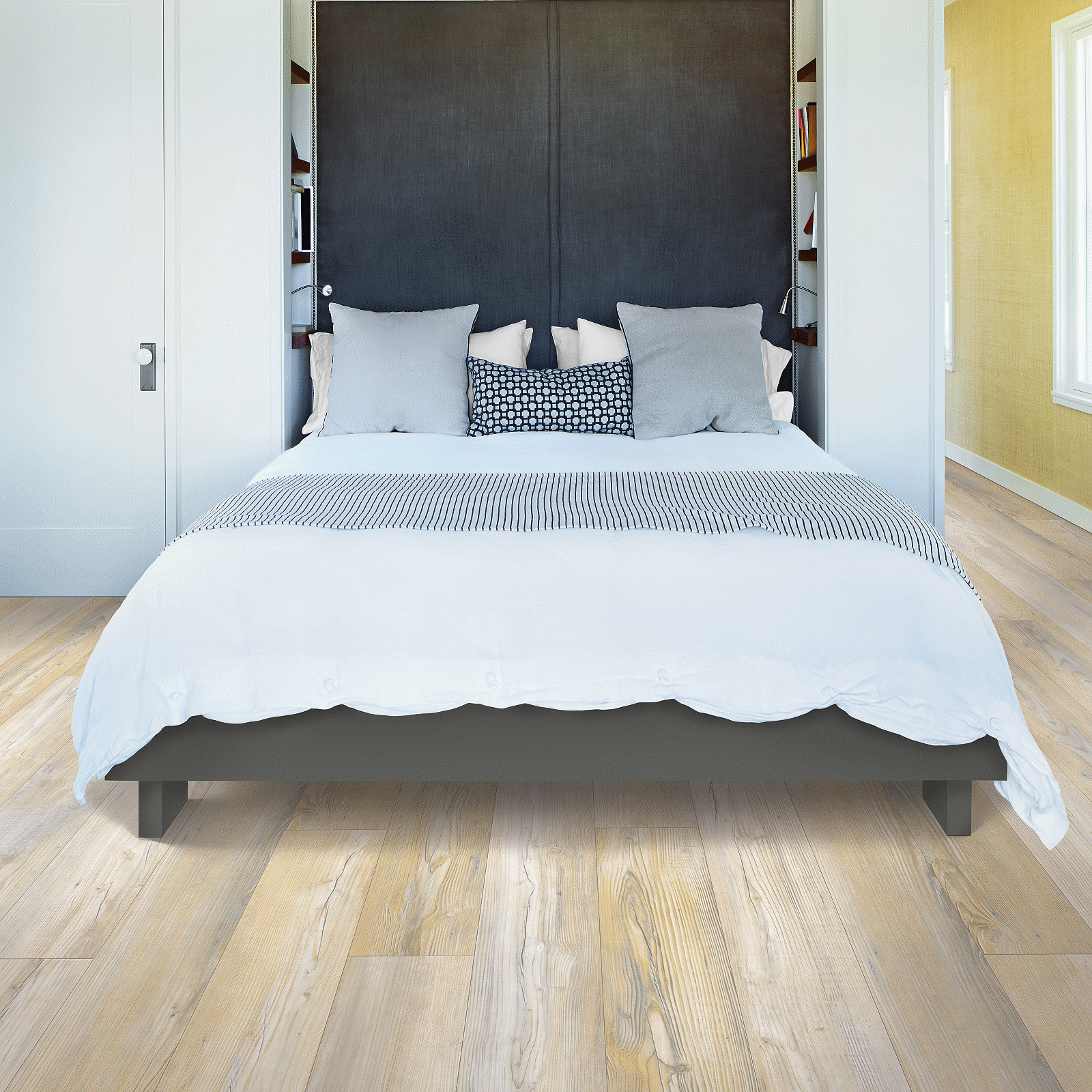 A bed room with a white and black bed