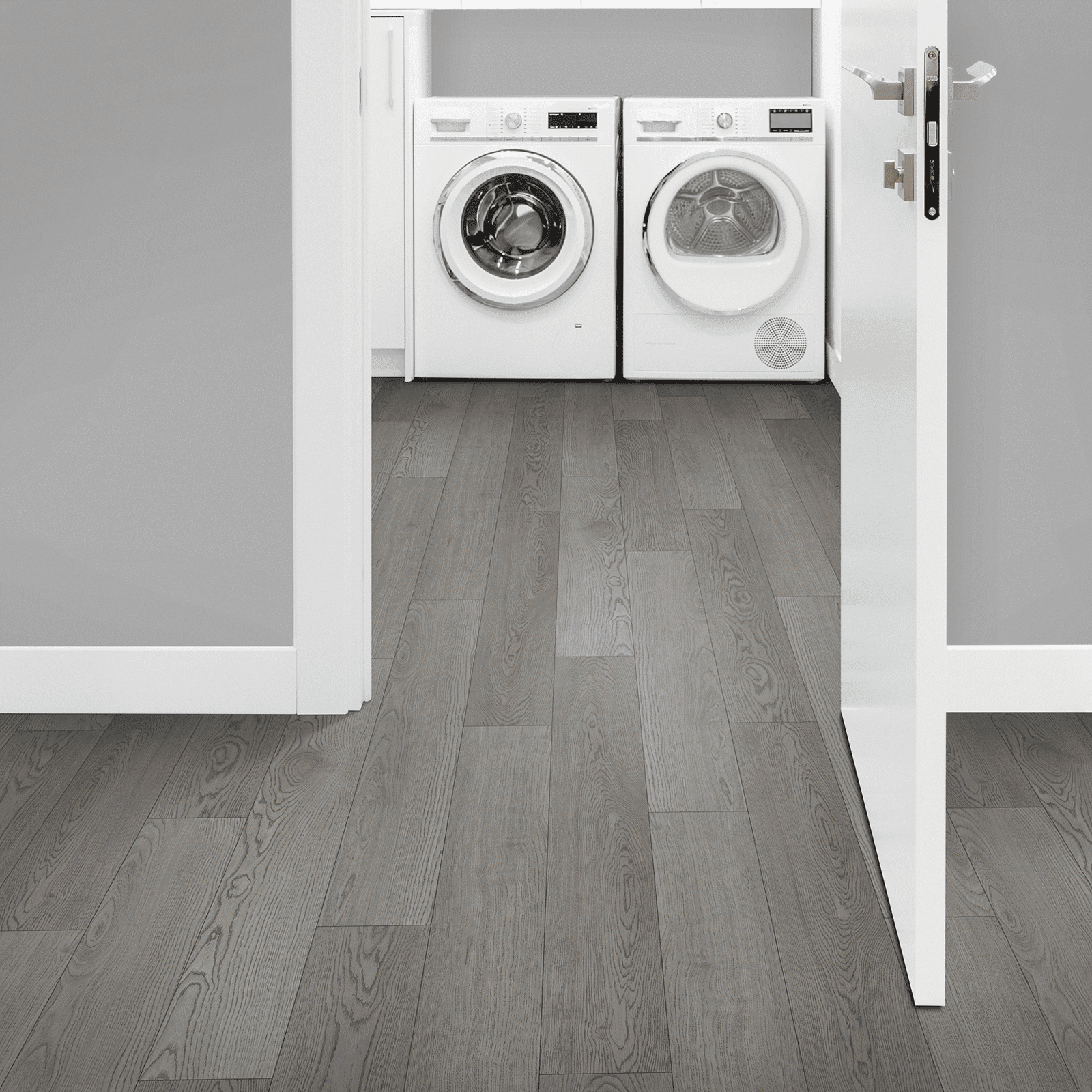A view of two washing machines from the doorway.