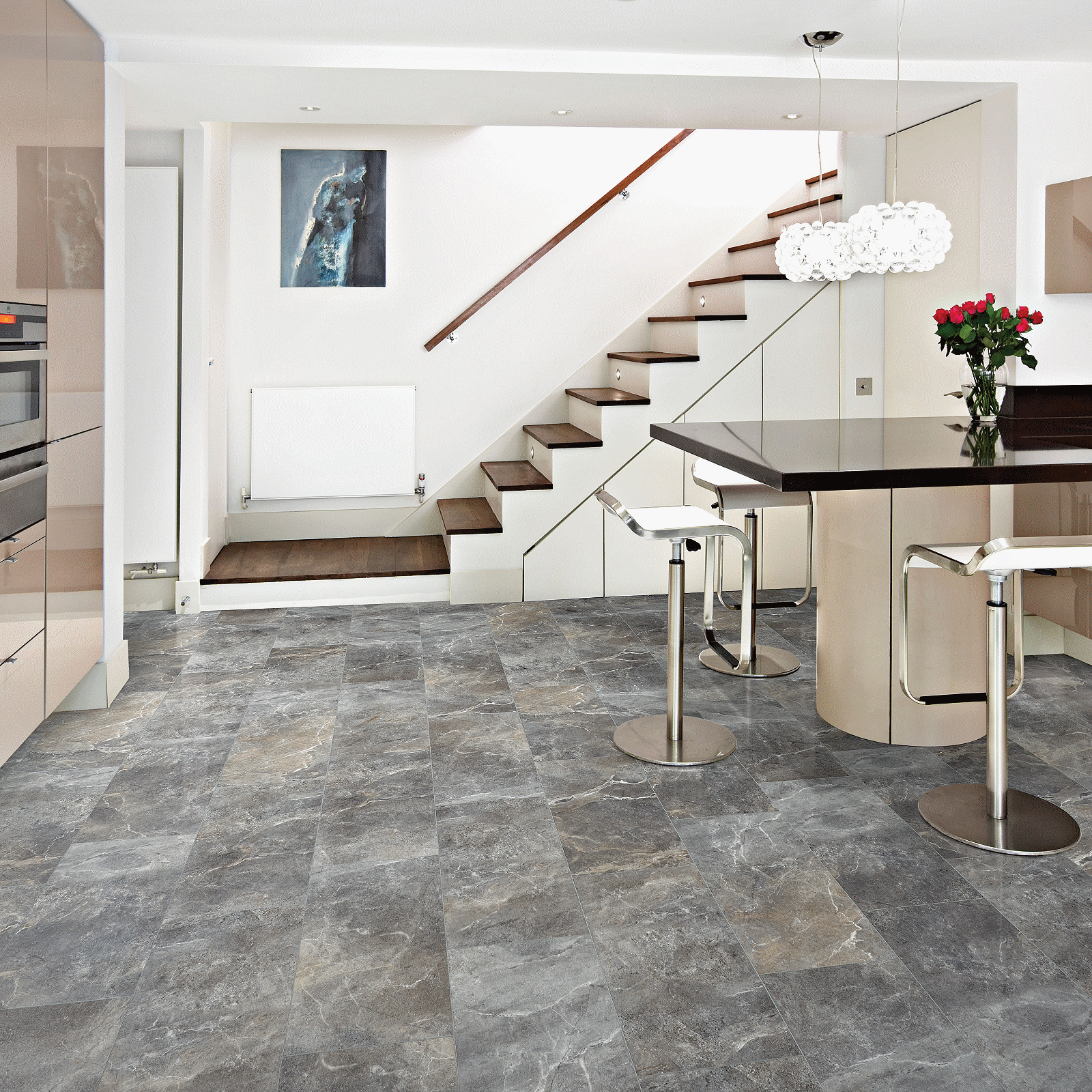 A kitchen with stairs and a table in it