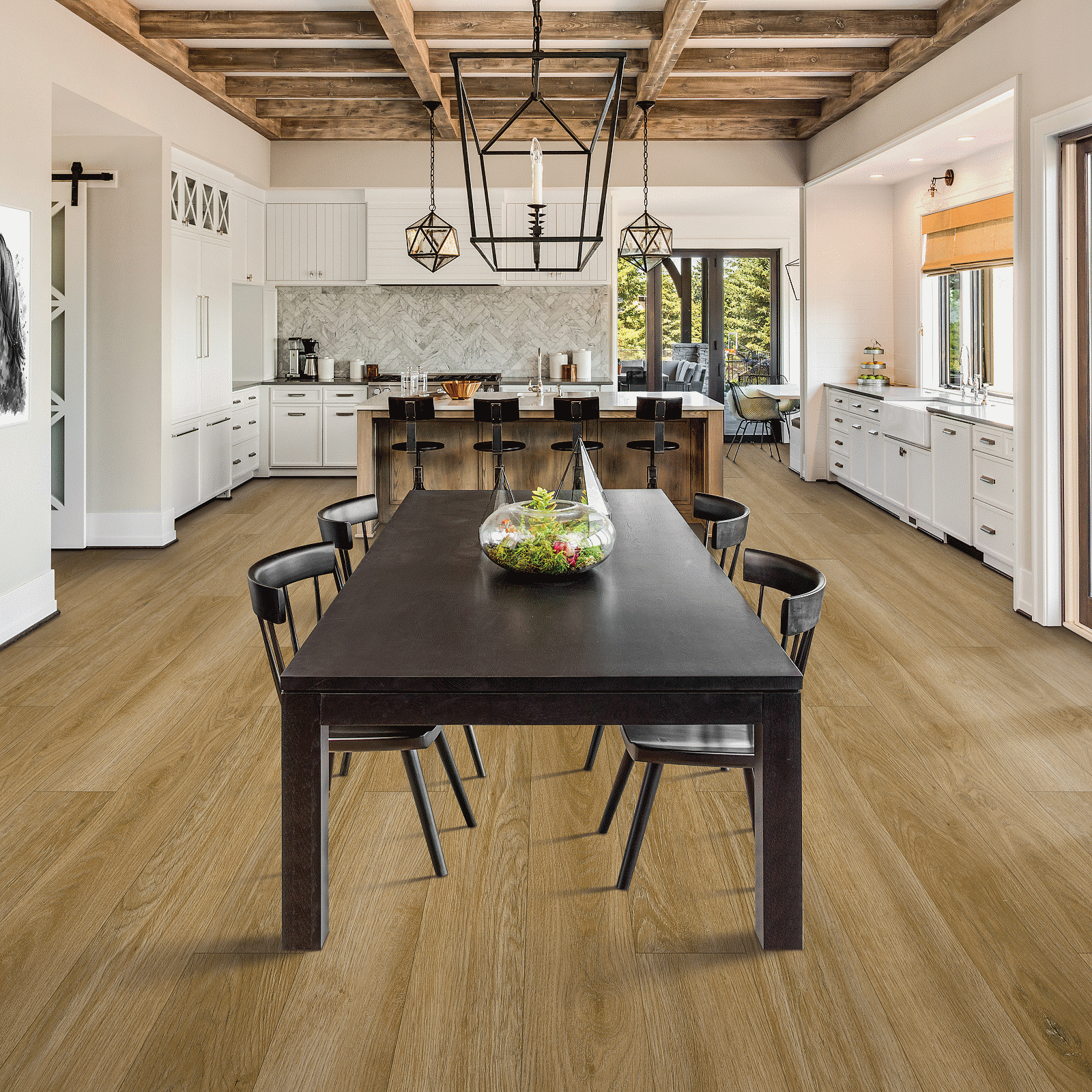 A large dining room with wooden floors and white walls.