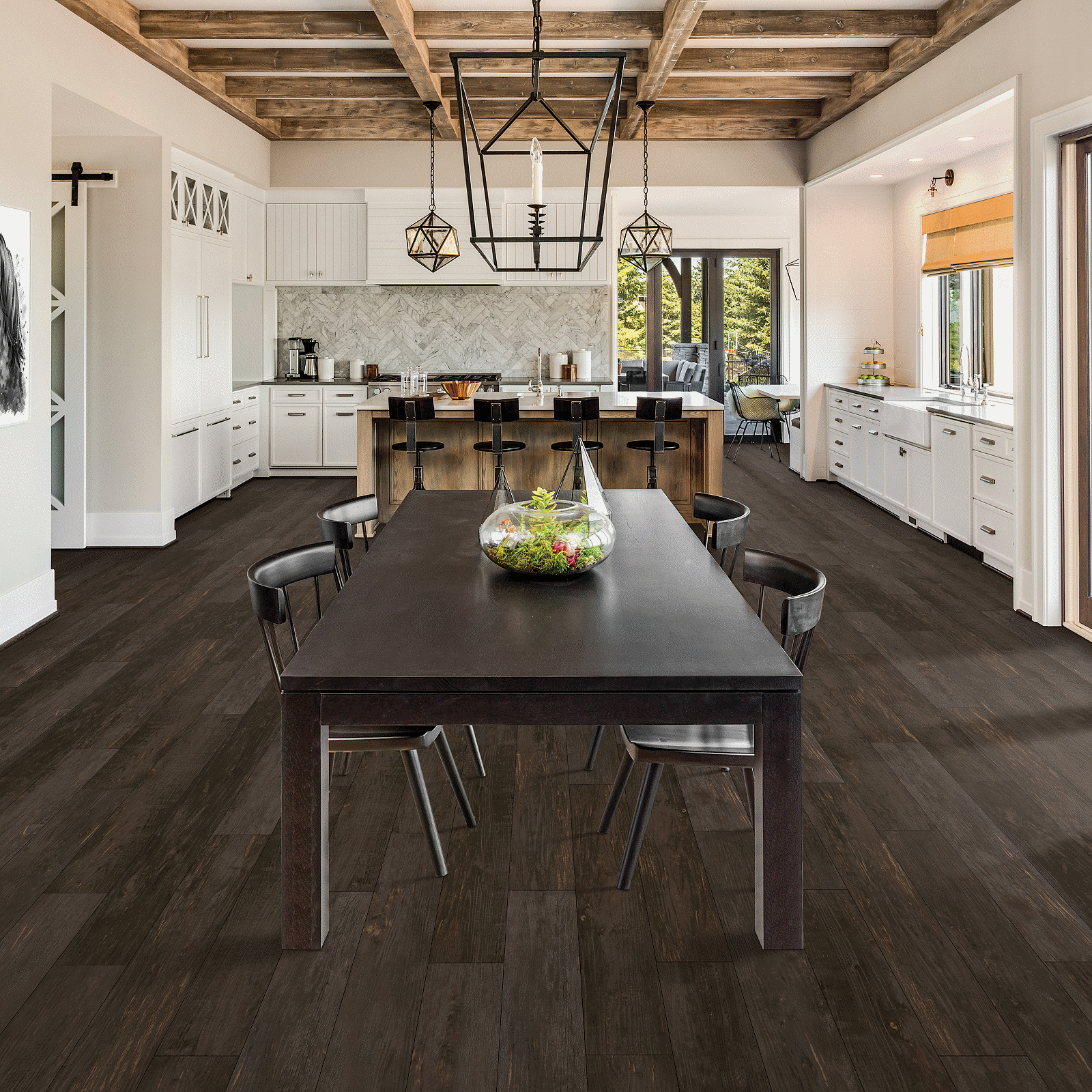 A kitchen with dark wood floors and white walls.