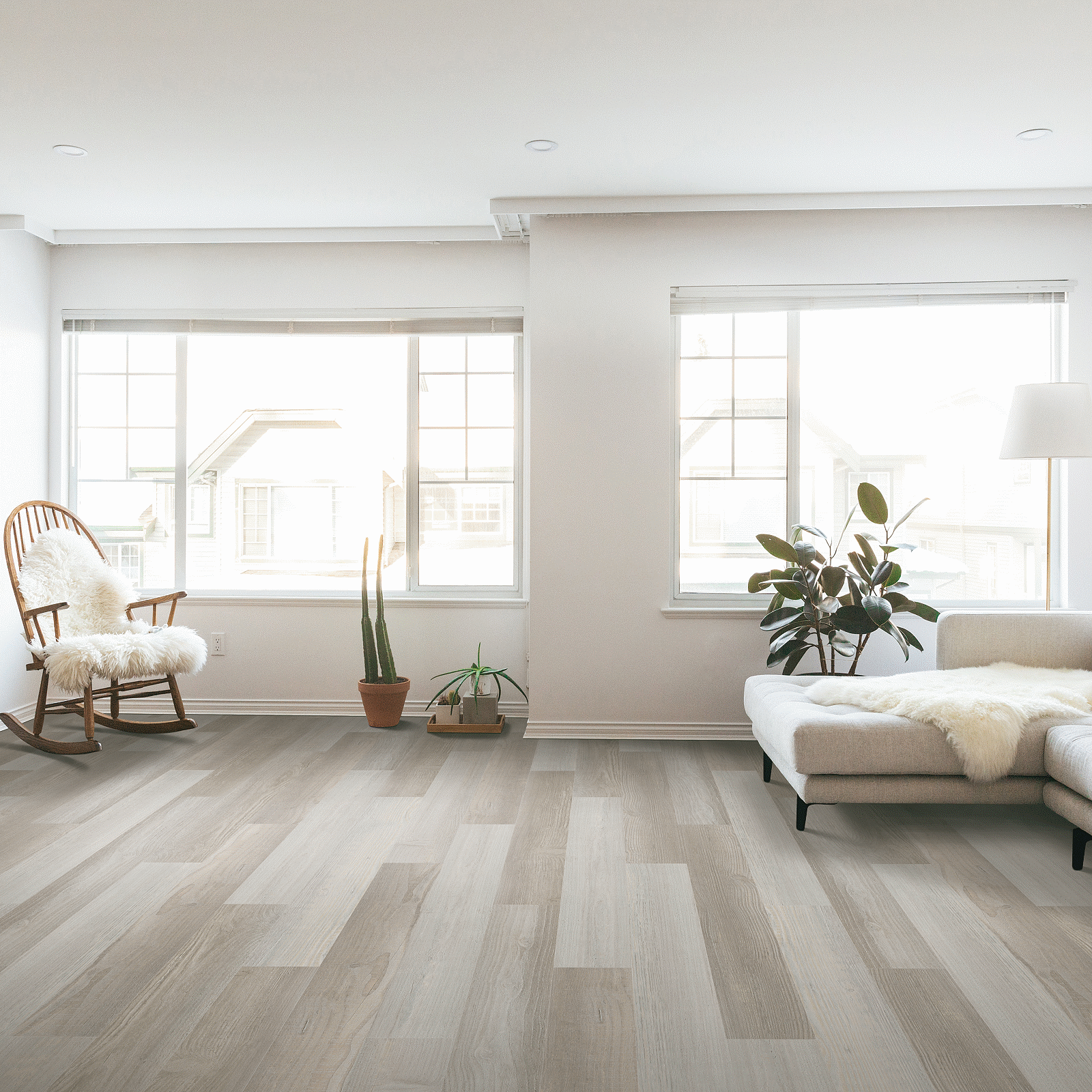 A living room with hard wood floors and large windows.