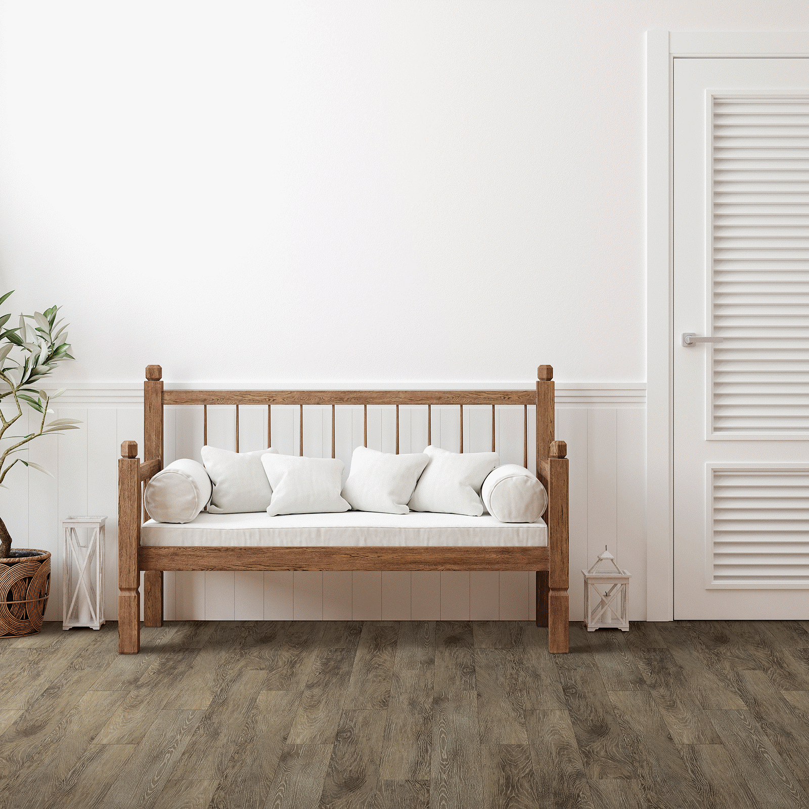 A wooden bench with pillows in front of a white door.