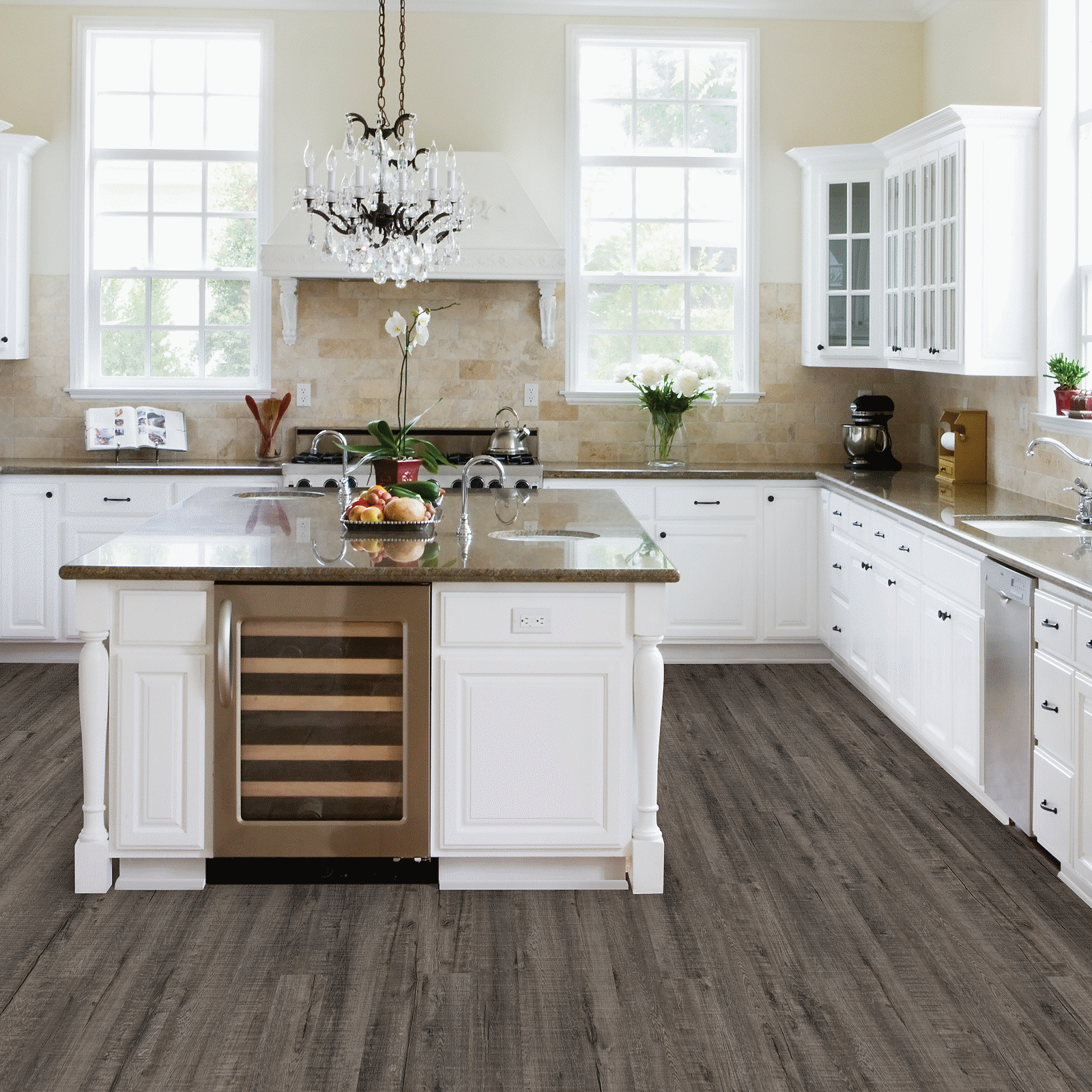 A kitchen with white cabinets and brown floor