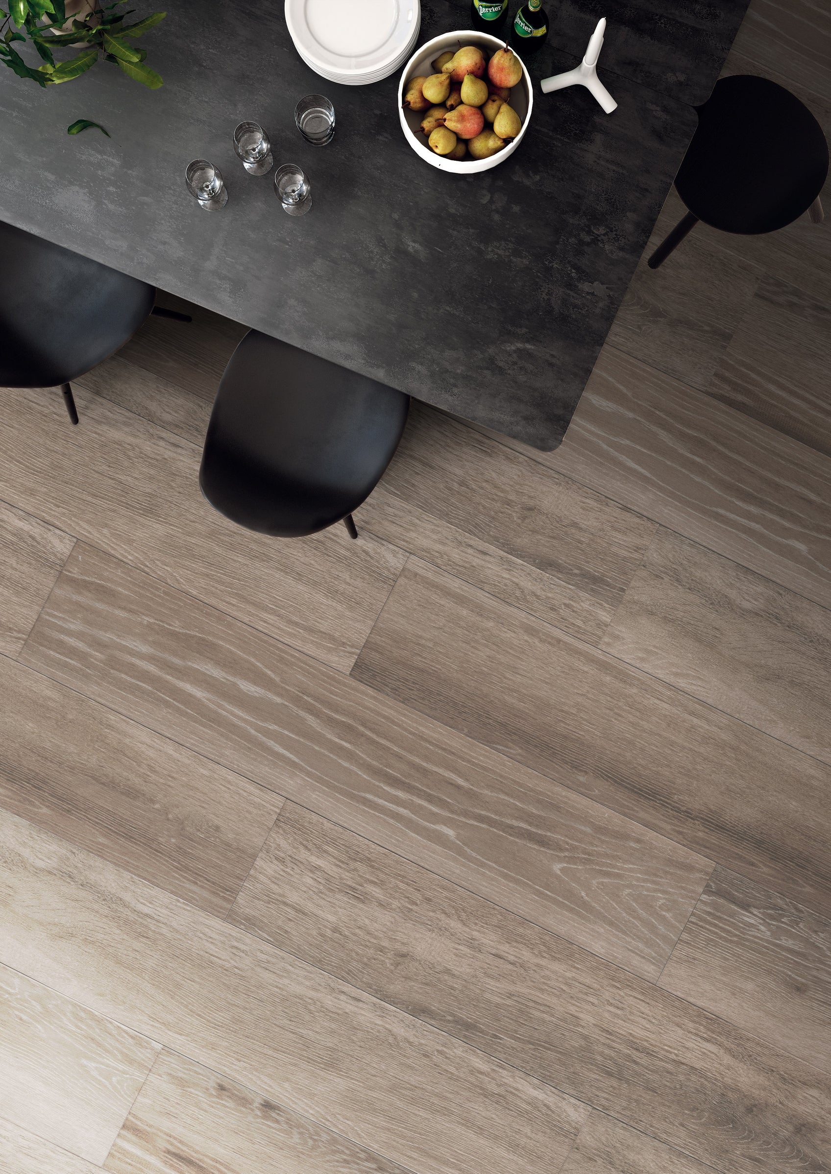 A table and chairs in front of a wooden floor.