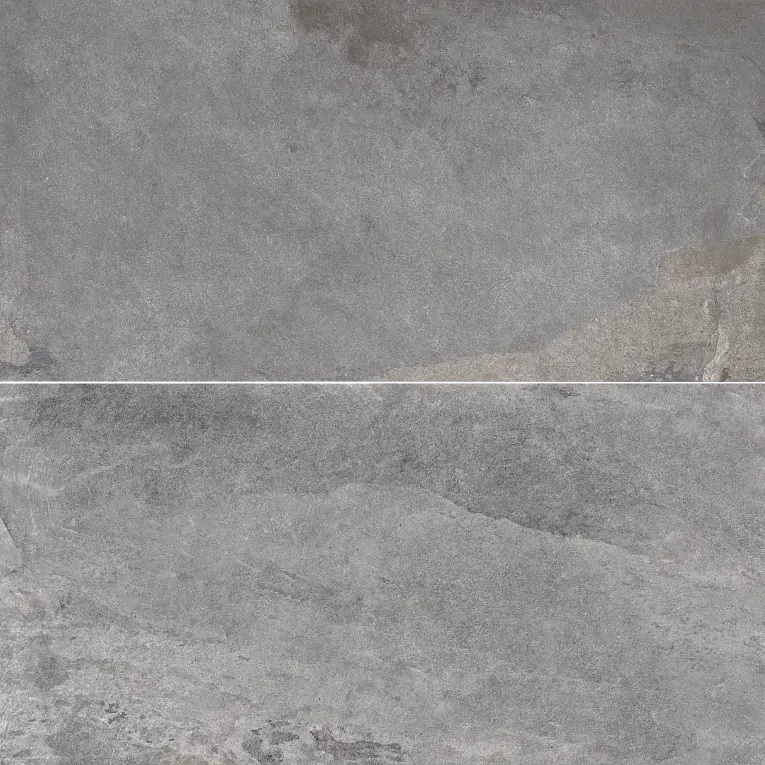 A gray stone wall with some white spots on it