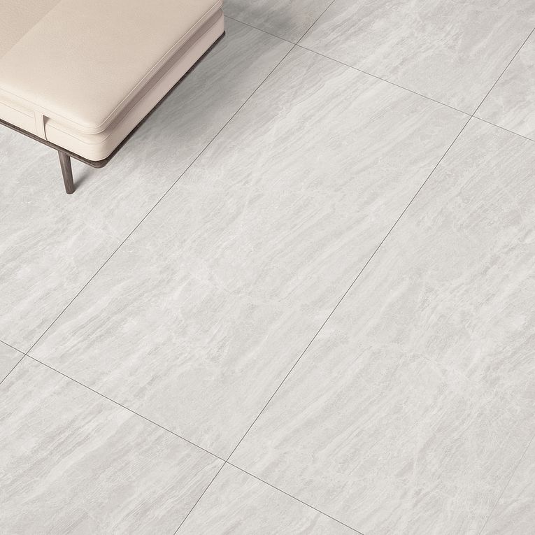 A white tile floor with a bench in the background.