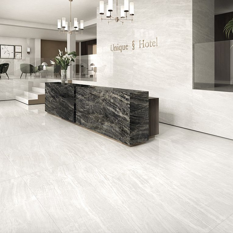 A lobby with marble floors and walls.