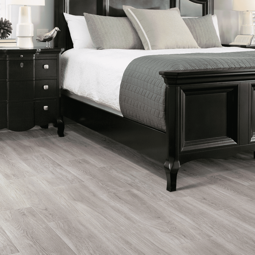 A bedroom with a bed and nightstand in it