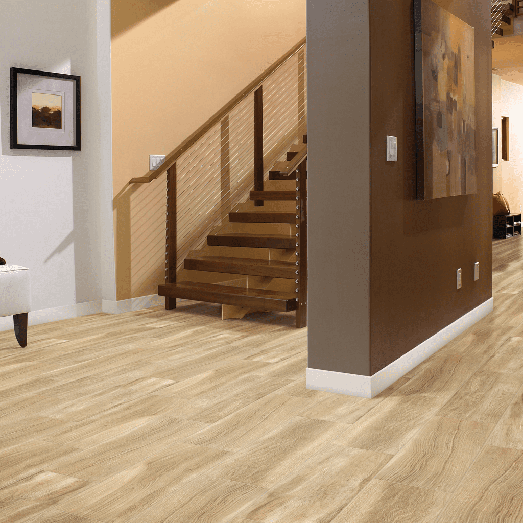 A room with stairs and a painting on the wall.