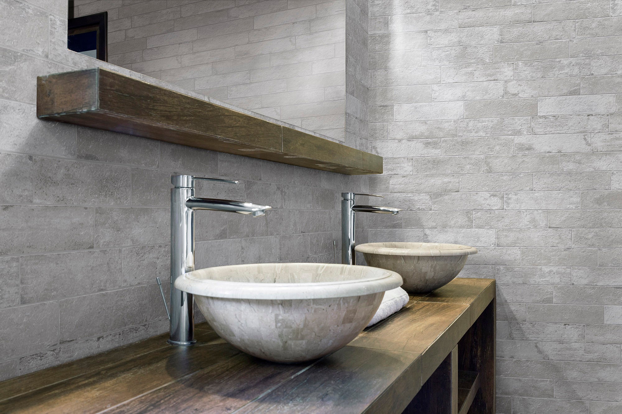 A bathroom with two sinks and a wooden counter.