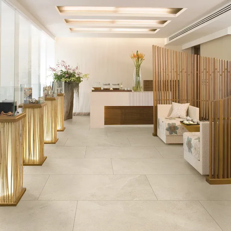A lobby with white walls and wooden columns.