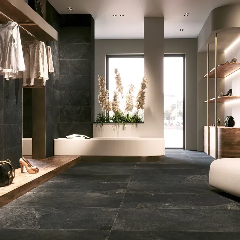 A room with a large black tile floor.