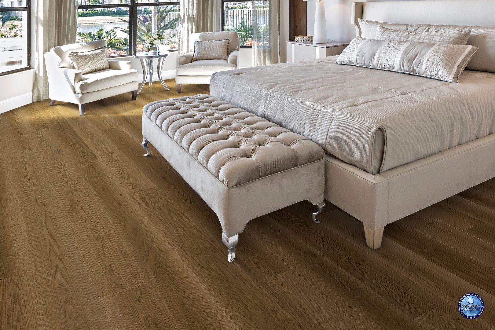 A bedroom with a large bed and bench in it.