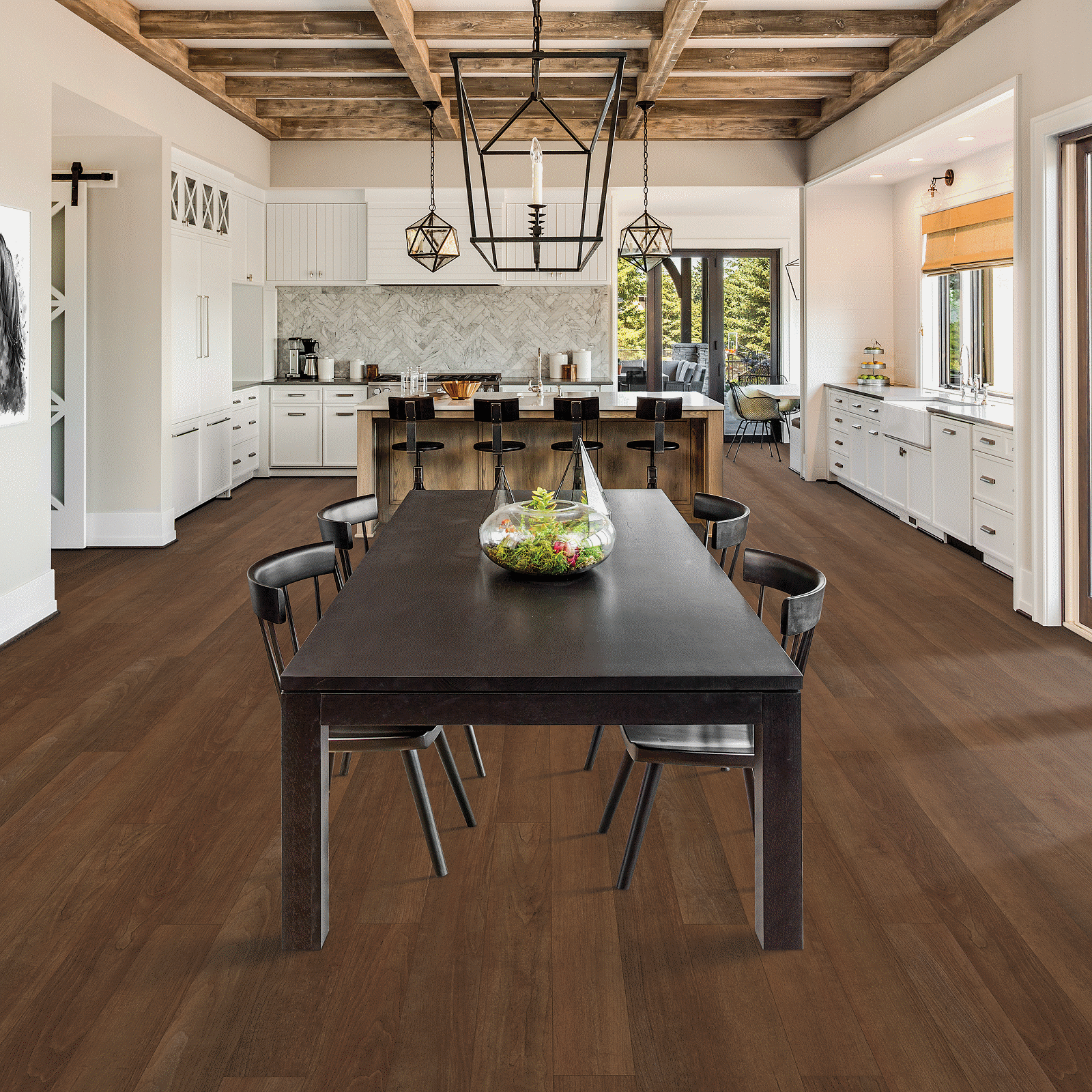A large dining room with wooden floors and white walls.