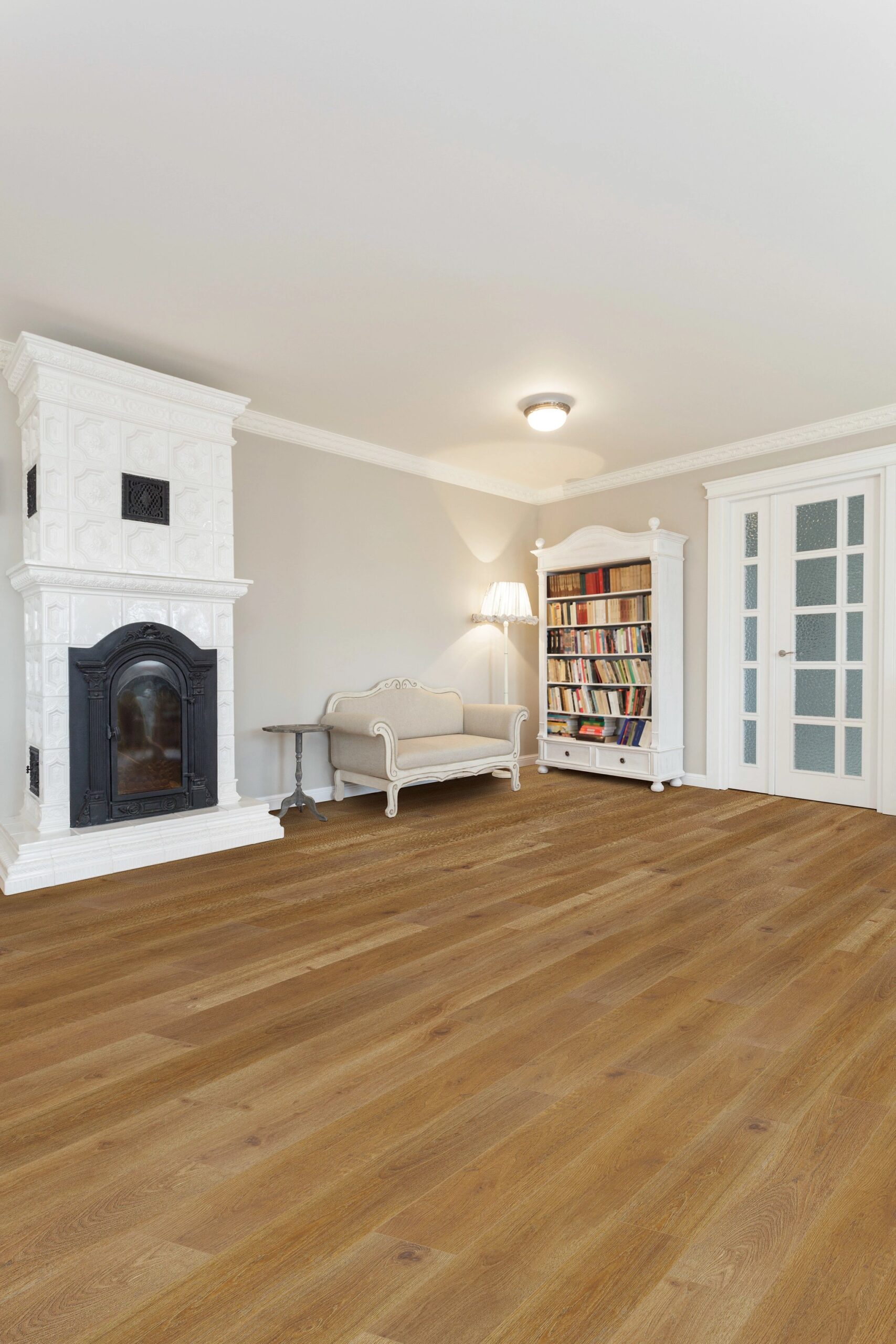 A living room with hard wood floors and white furniture.