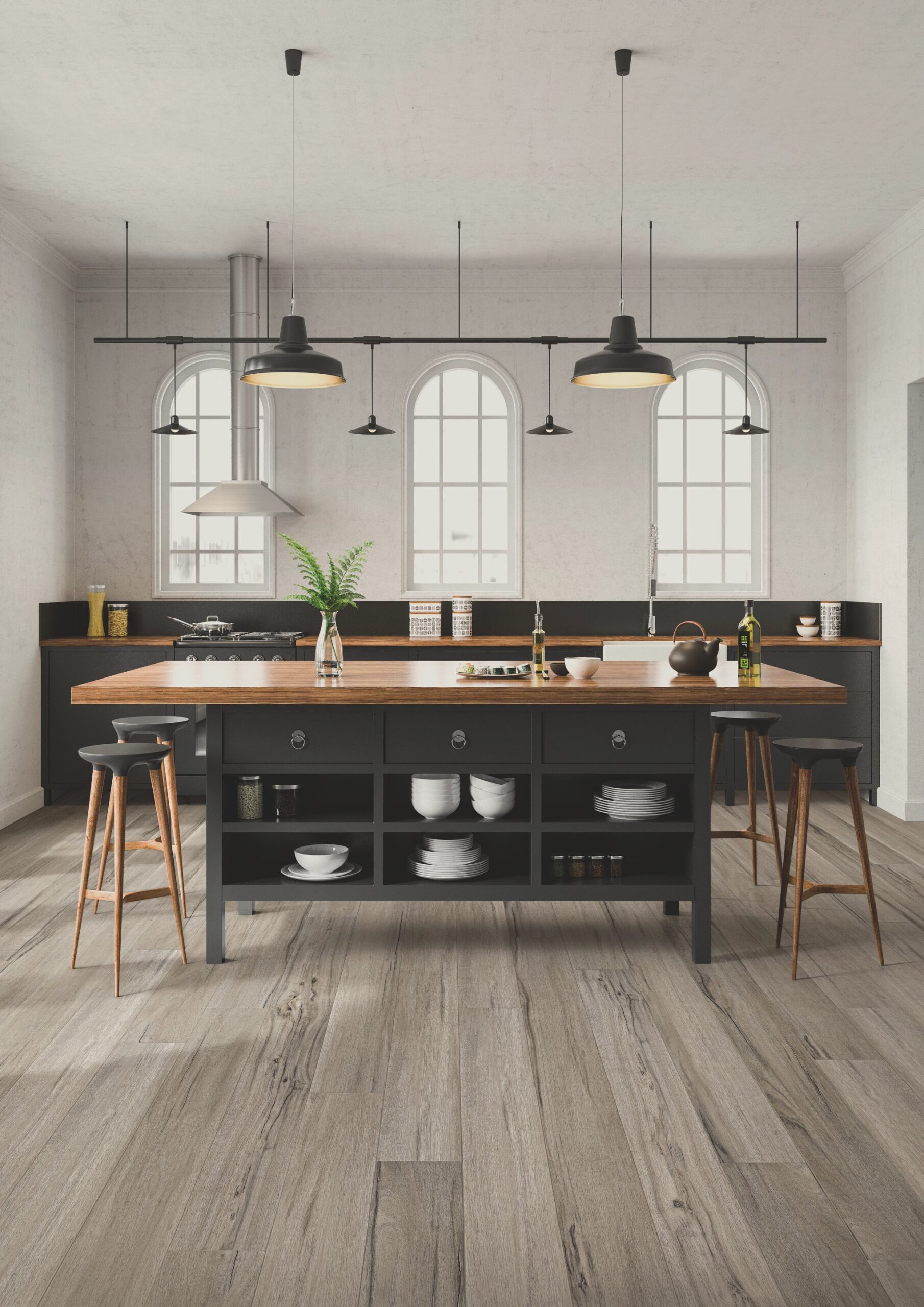 A kitchen with wooden floors and black cabinets.