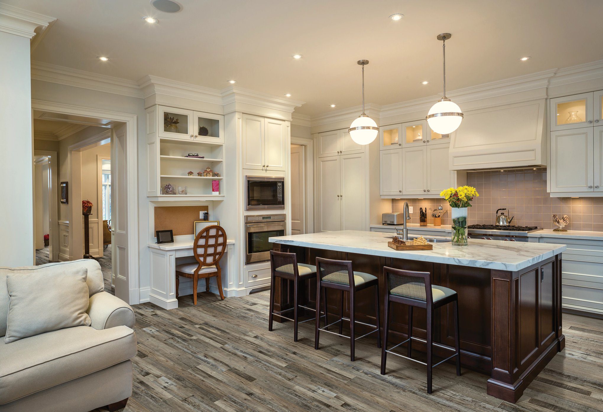 A kitchen with a large island and wooden floors