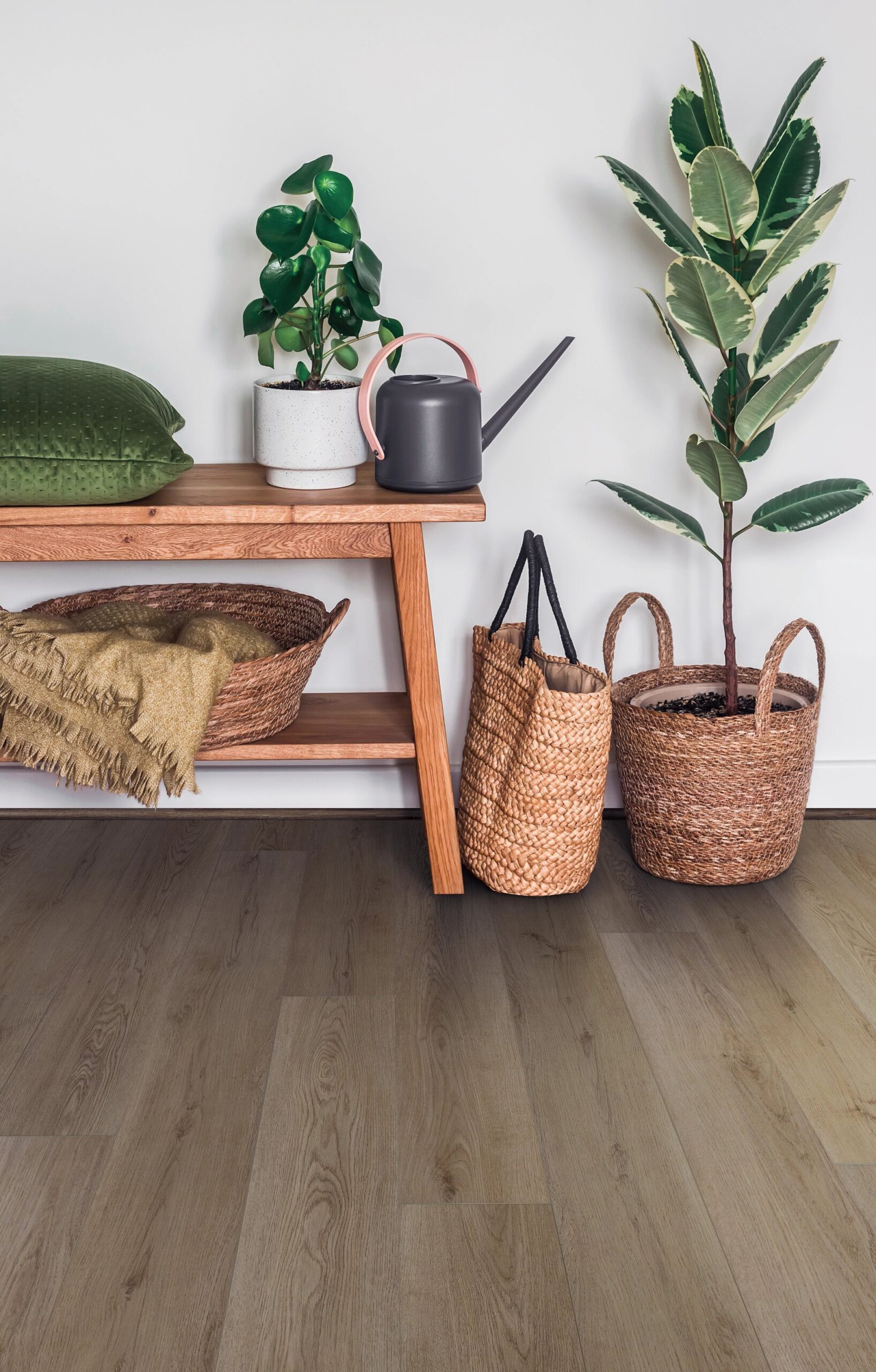 A wooden table with plants and baskets on it.