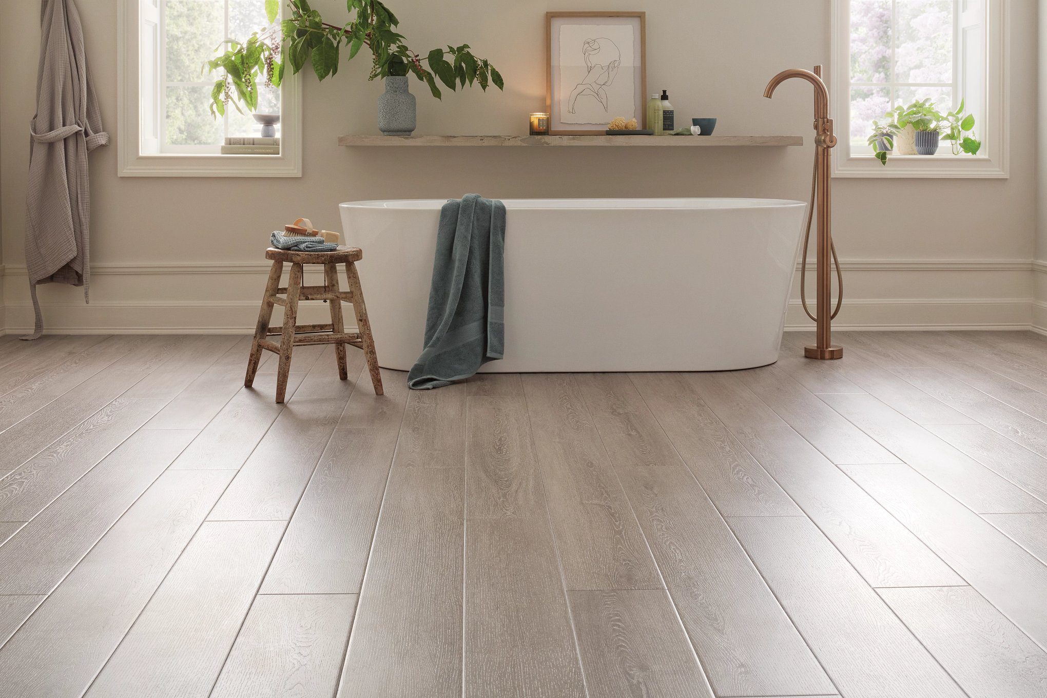 A bathroom with wooden floors and white walls.