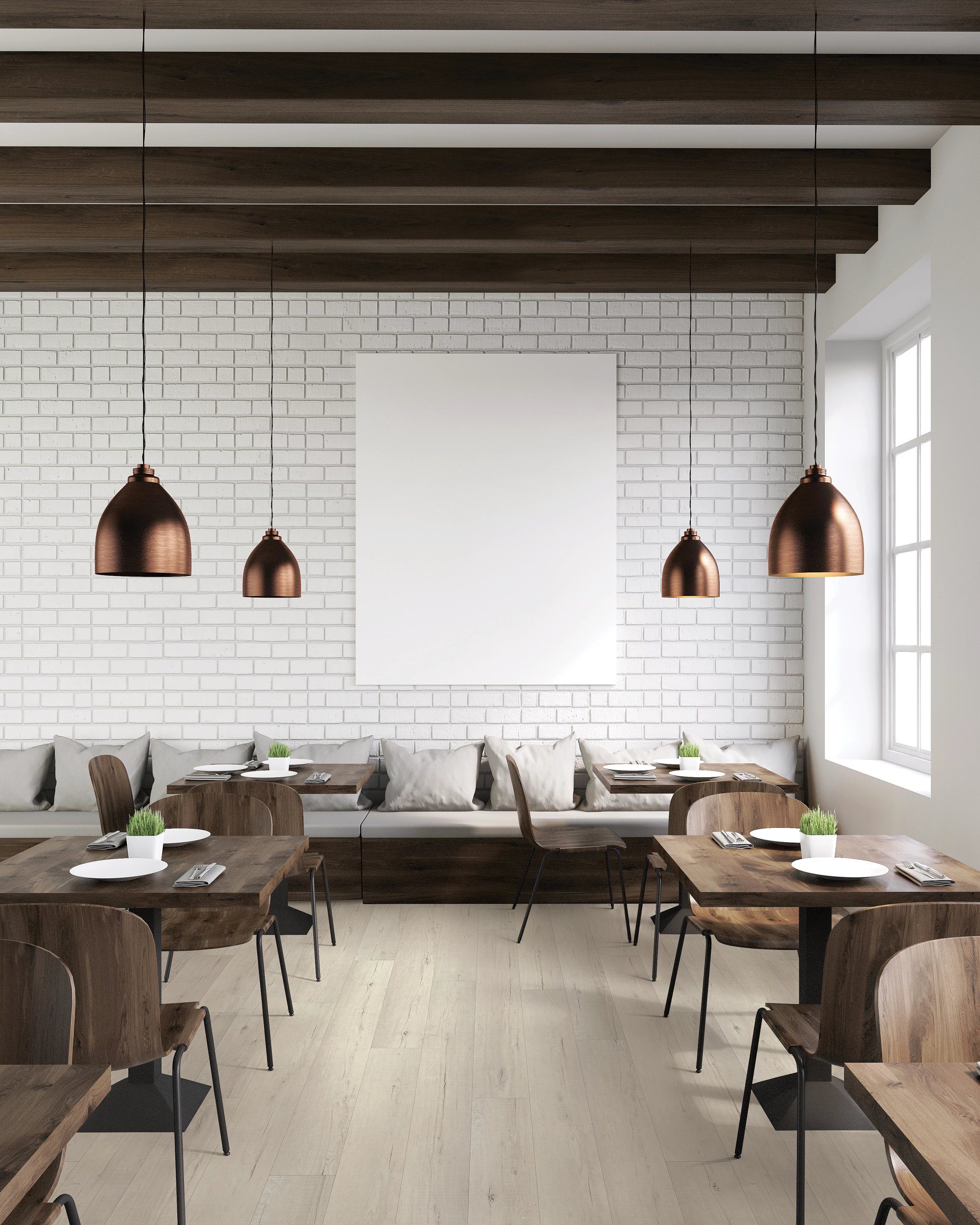 A restaurant with tables and chairs, some hanging lights.