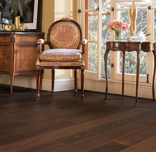 A chair and table in front of a window.