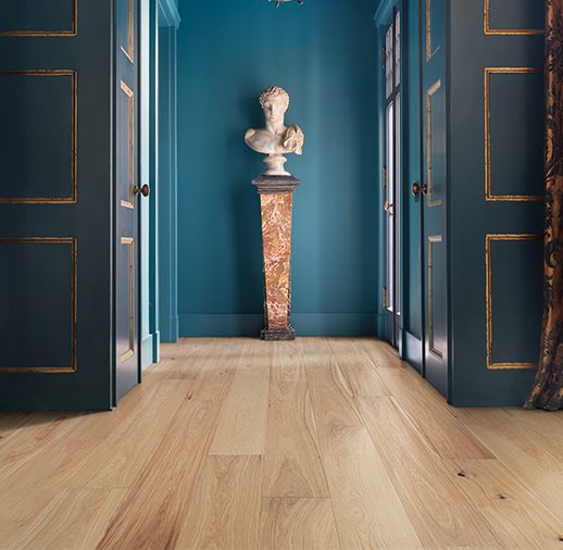 A hallway with two doors and a statue in the middle.