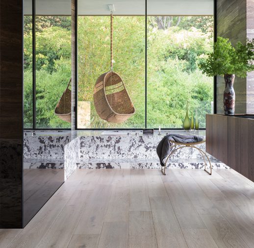 A room with a large window and wooden floors