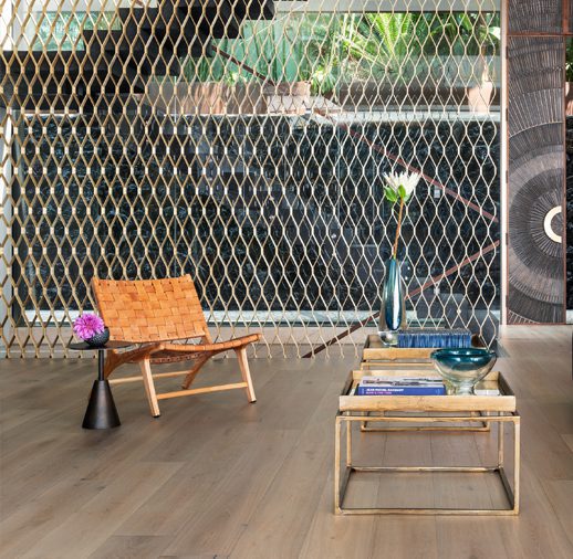 A chair and table in front of a wall.